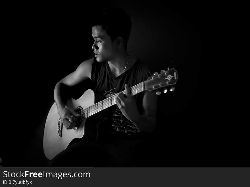 Monochrome Photography of Man Playing Guitar