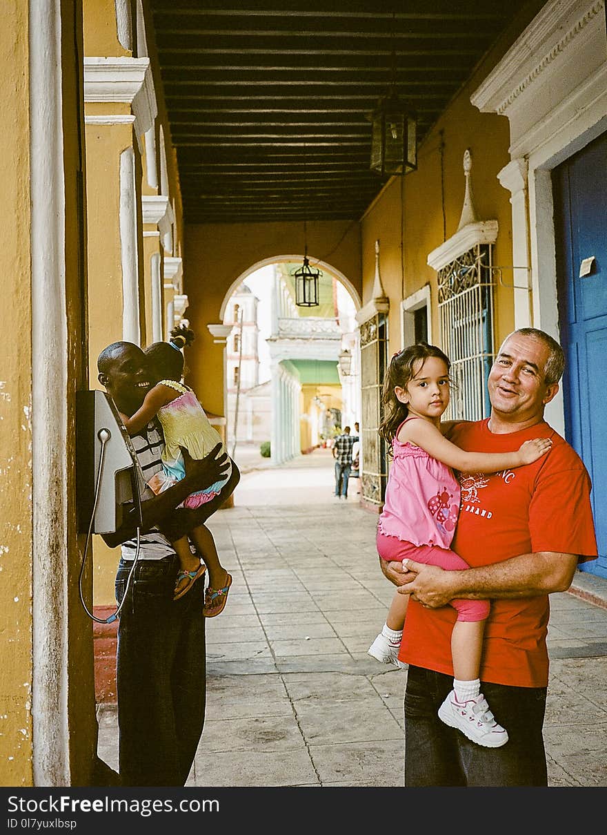 Two Man Carrying Child