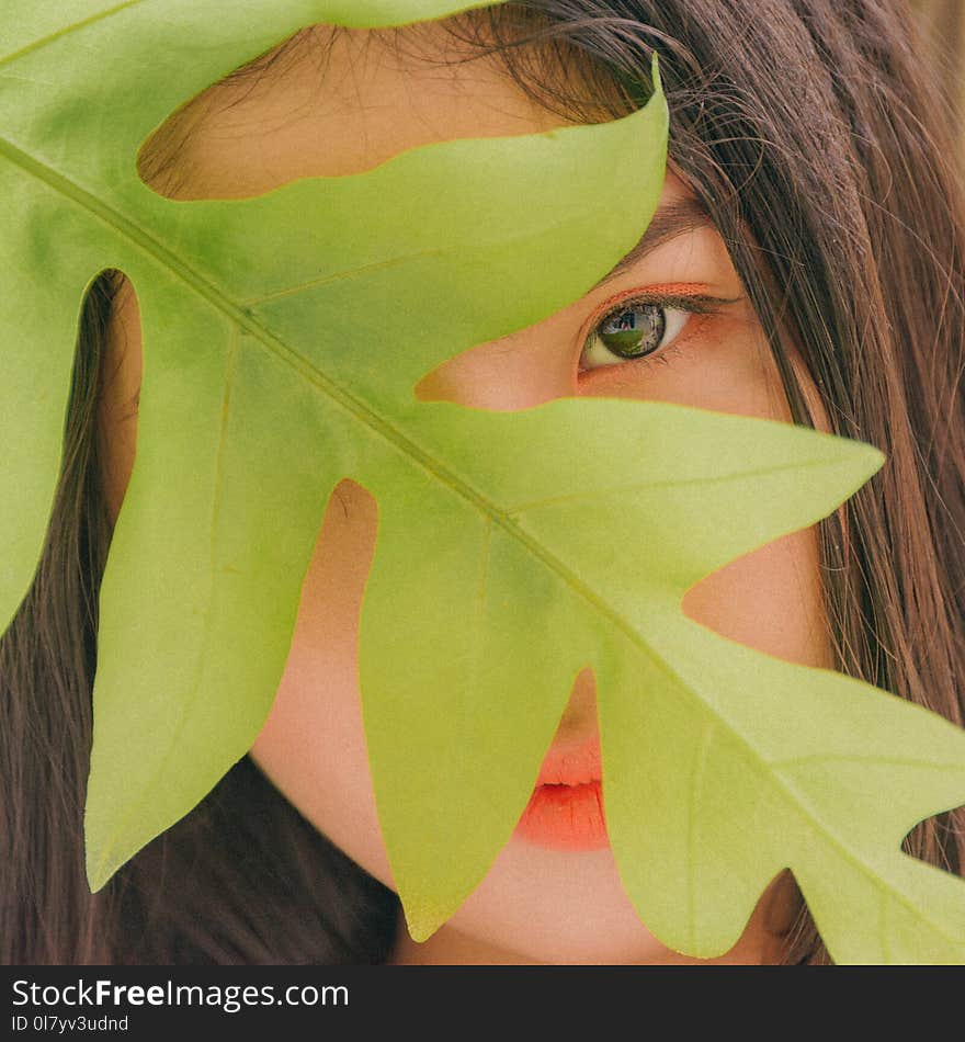 Photography of Woman Near Leaf