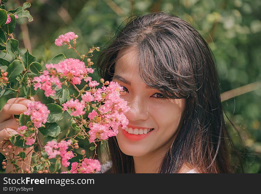 Photography of Smiling Woman Near Flowers