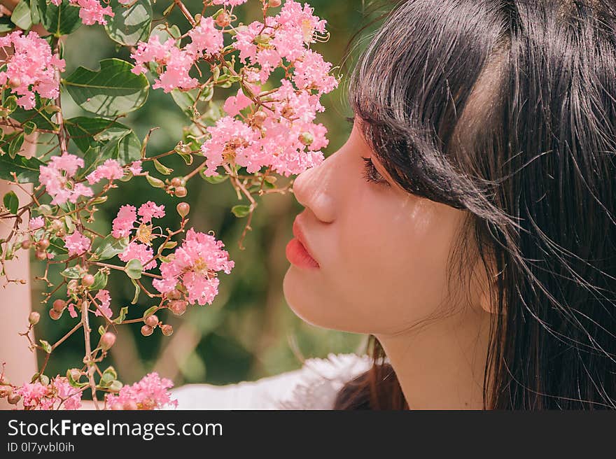 Close-Up Photography of Girl Near Pink Flower