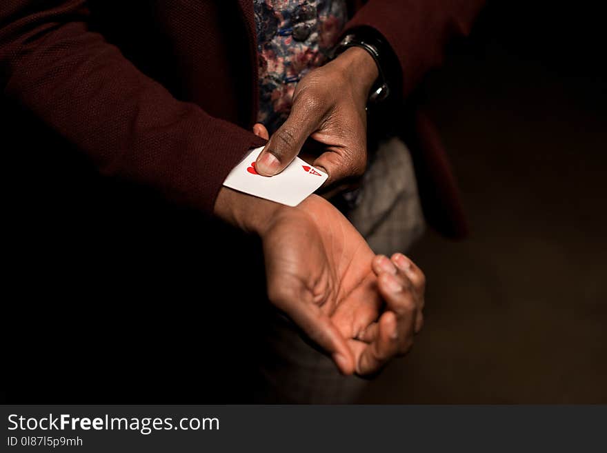 cropped view of african american man with ace in sleeve