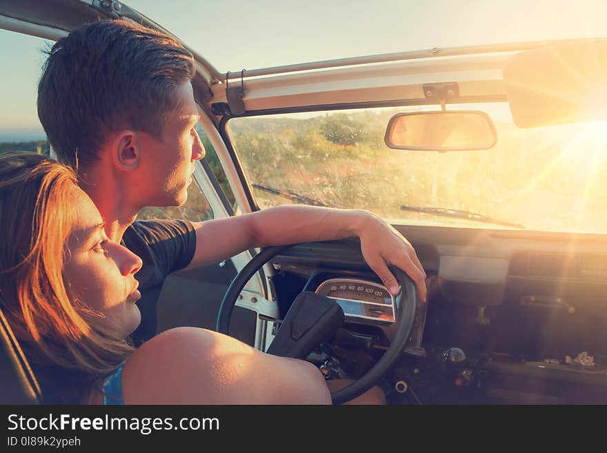 Happy couple in a car enjoying sunset. Happy couple in a car enjoying sunset.