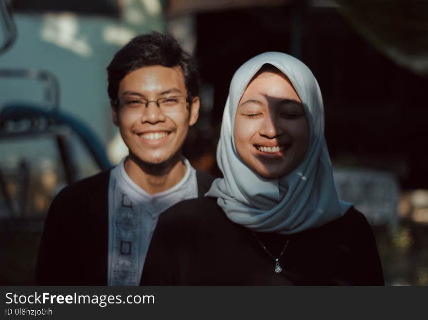 Woman Standing in Front of Man