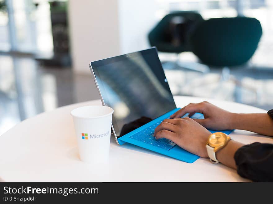 Person Browsing on Black and Blue Laptop Computer