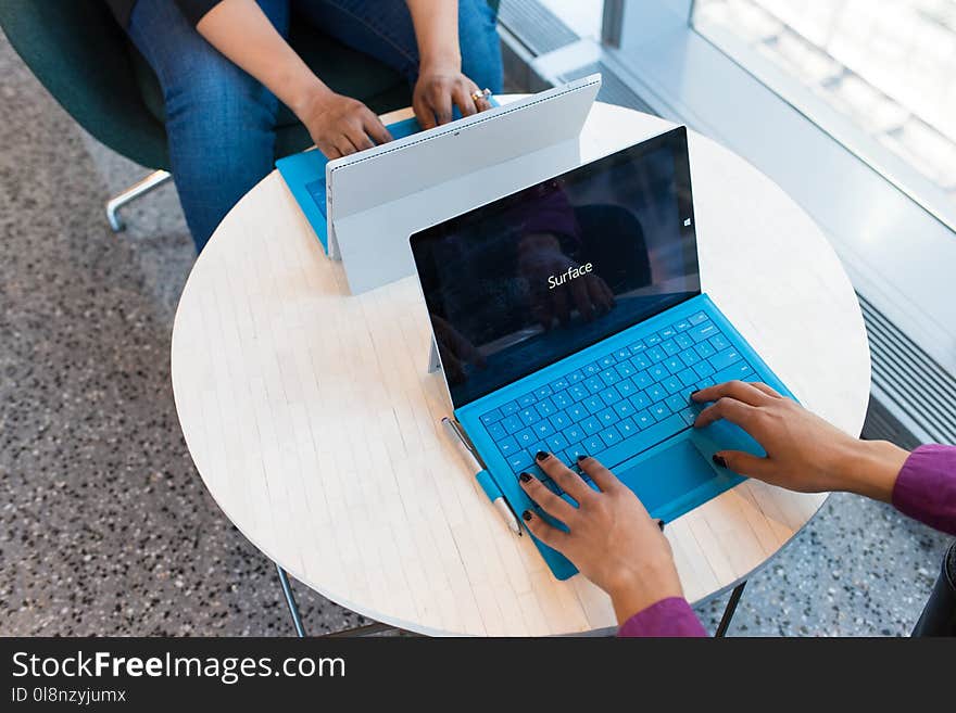 Two Black-and-blue Laptop Computers on White Table