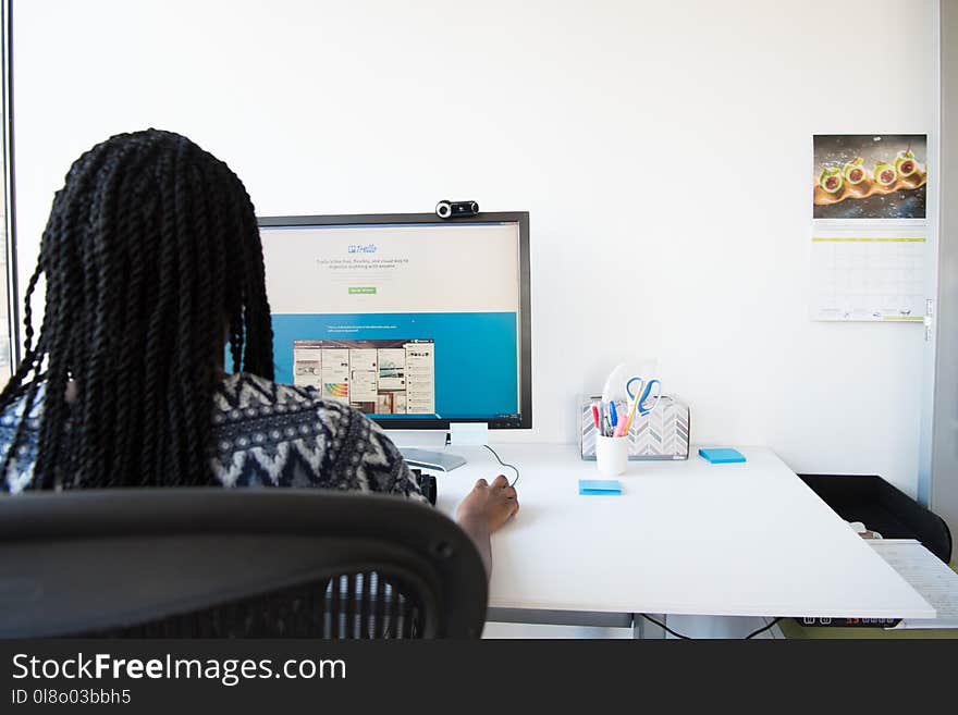 Woman Sitting on Chair Using Computer