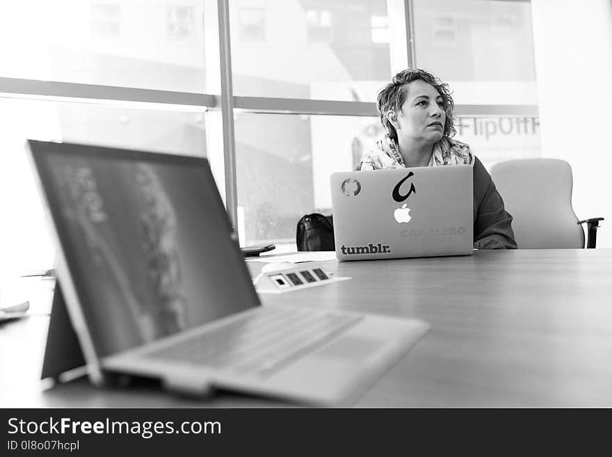 Grayscale Photography of Laptop Computer Near Woman Sitting on Chair