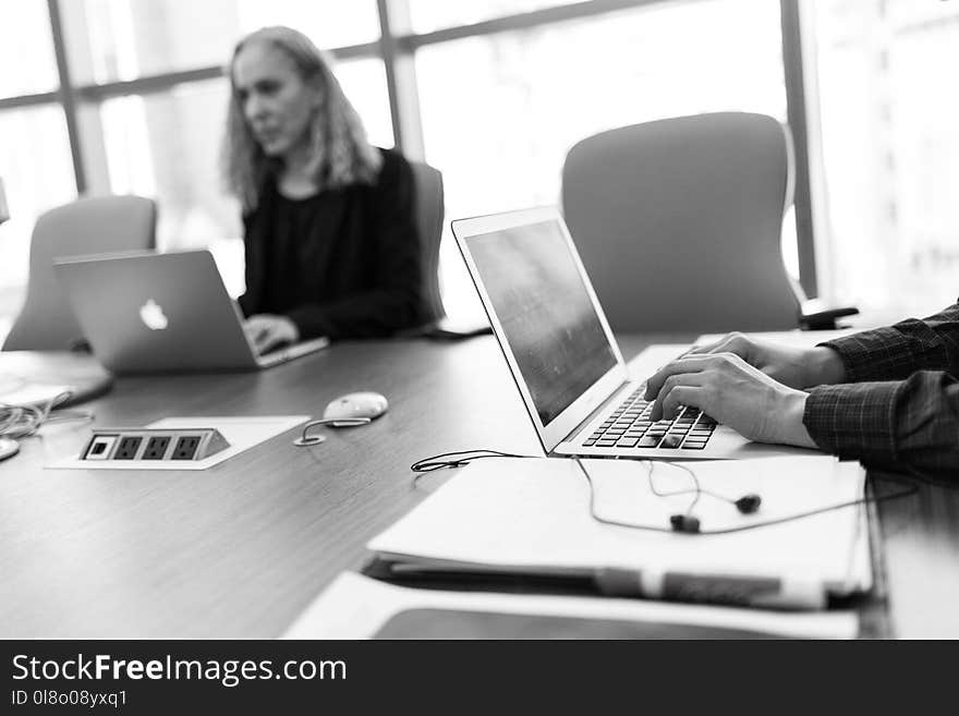 Grayscale Photo of Person Using Laptop Computer