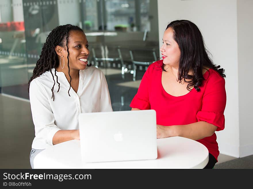 Woman in Red Shirt Beside Woman in White Shirt