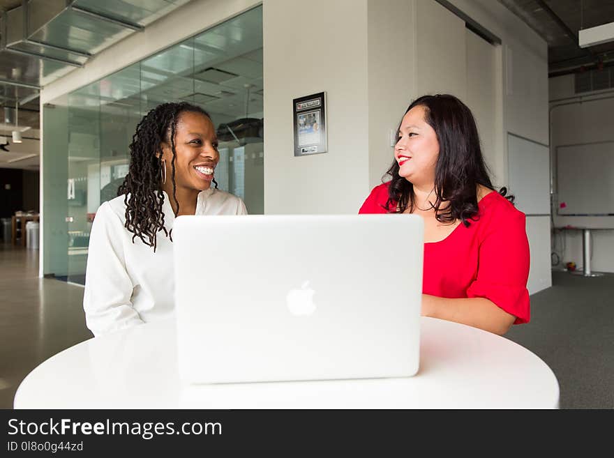 Two Women in Front of Silver Macbook