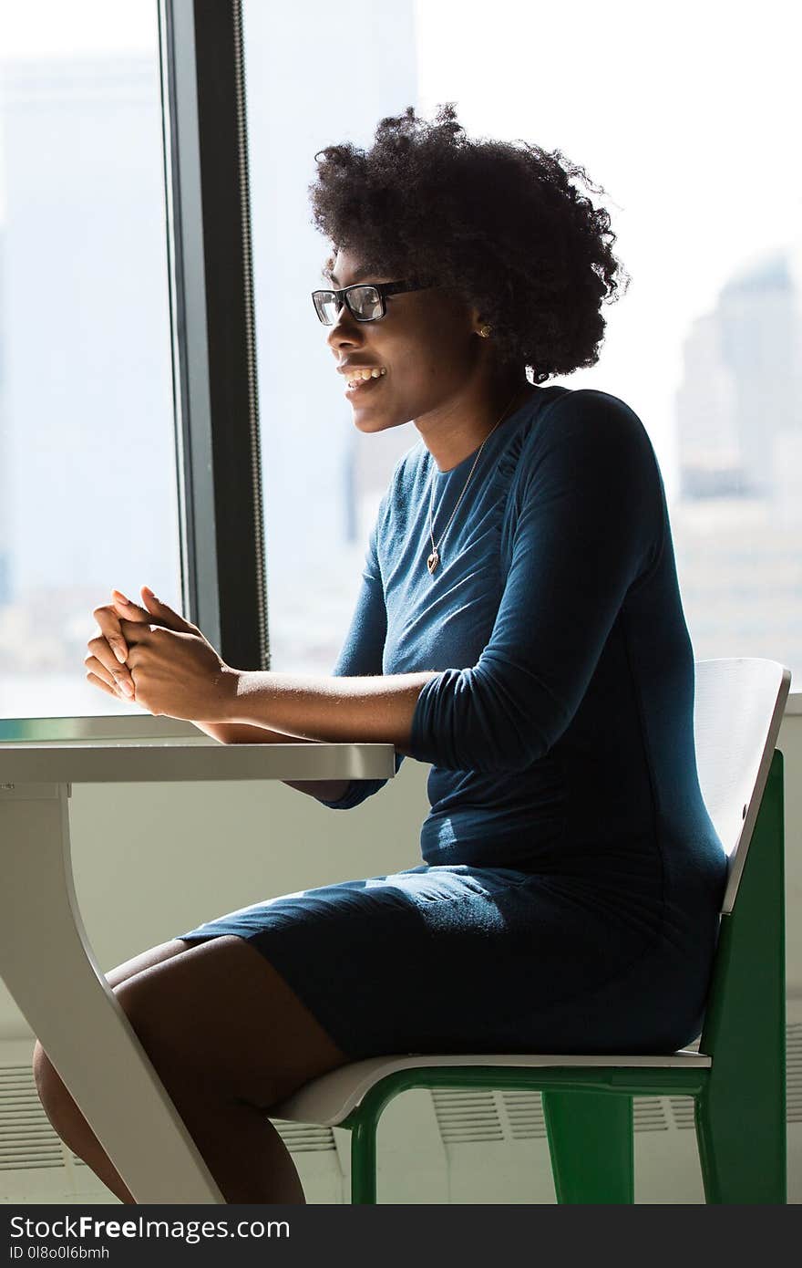 Woman Wearing Eyeglasses Sitting Beside Table and Window