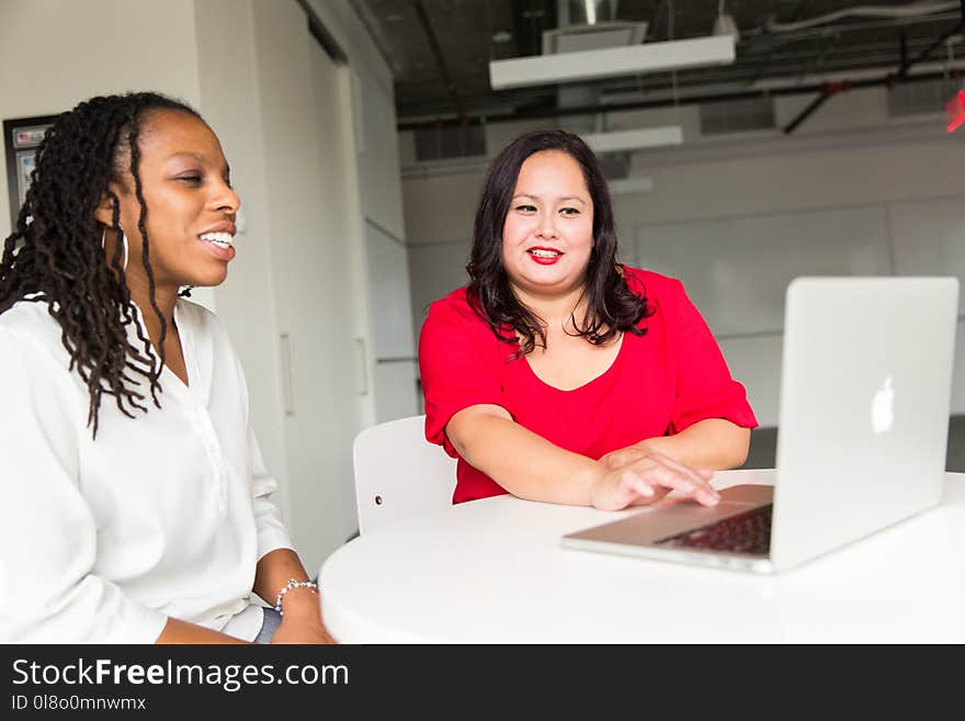 Woman Wearing Red Top Holding Silver Macbook