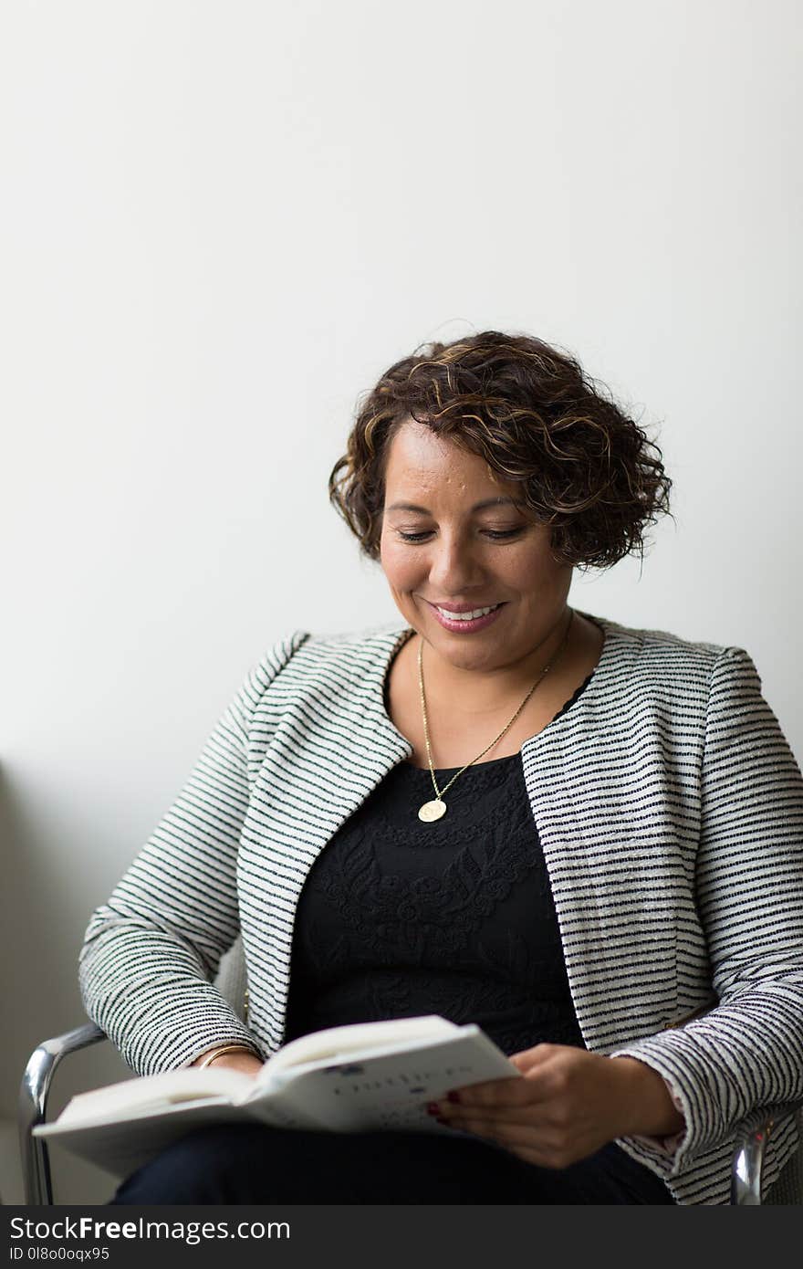 Smiling Woman While Reading Book