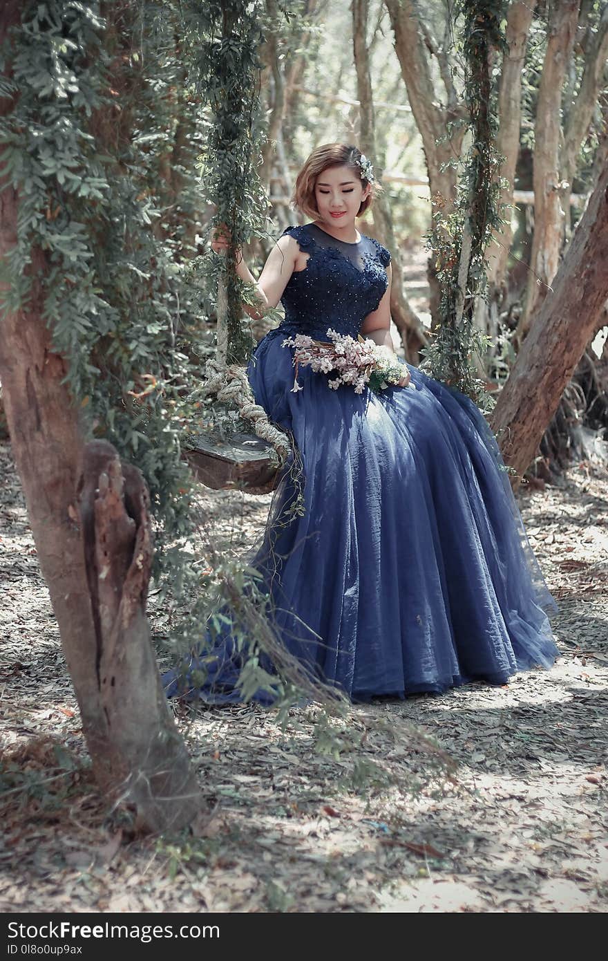 Woman in Black Floral Gown Sitting