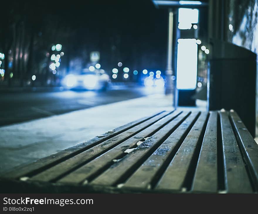 Selective Focus Photography Wooden Bench Beside Road