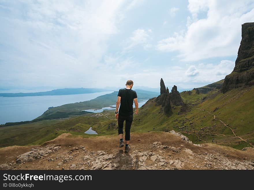 Man Wearing Black T-shirt Standing On Cliff