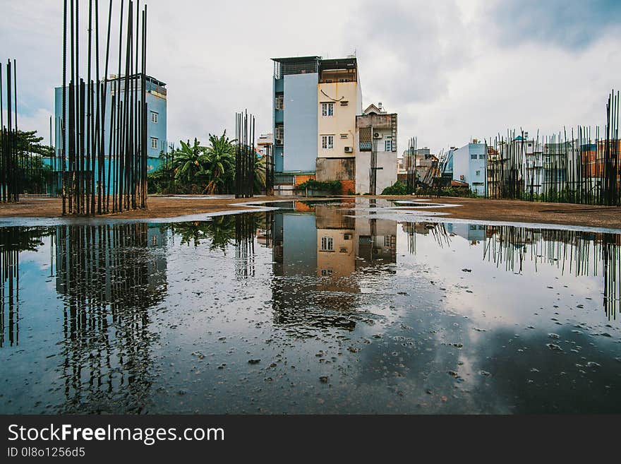 Body of Water Near Concrete Buildings