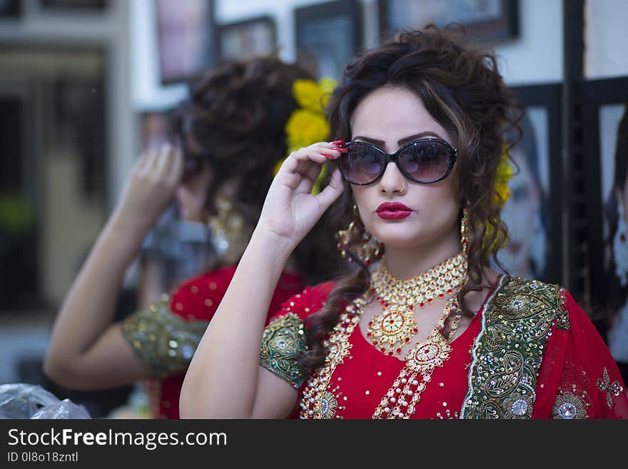 Woman Wearing Red Dress Holding Her Black Framed Sunglasses