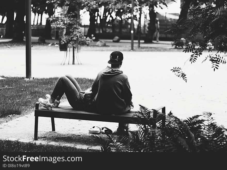 Grayscale Photo of a Couple sitting on a Bench