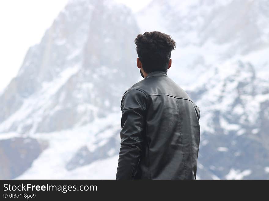 Man Wearing Black Jacket Looking at a Mountain