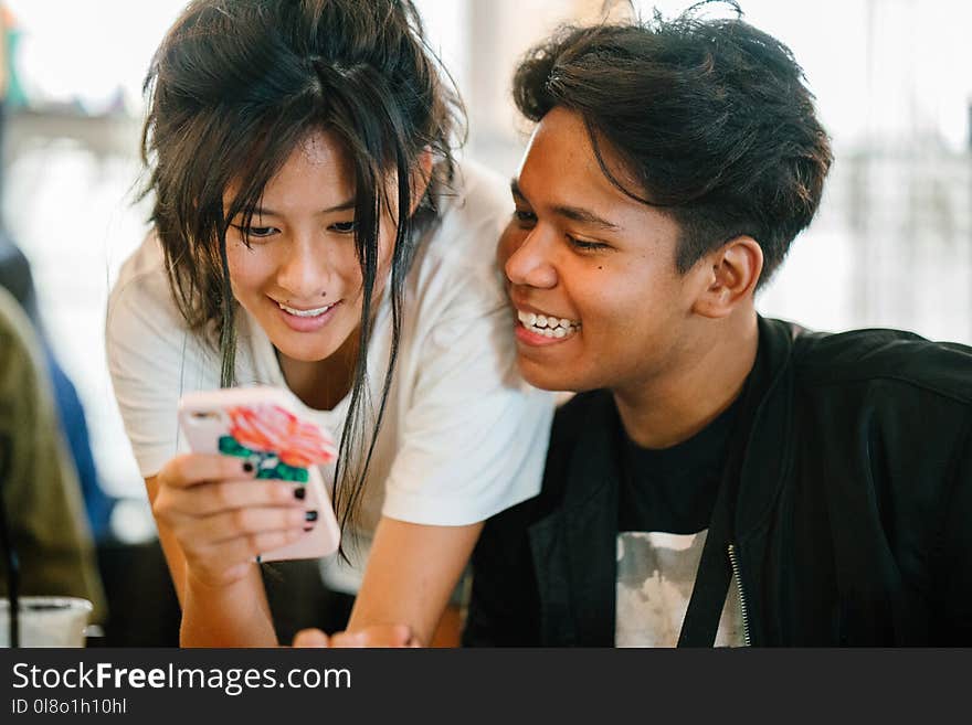 Woman Standing Near Man While Carrying Smartphone