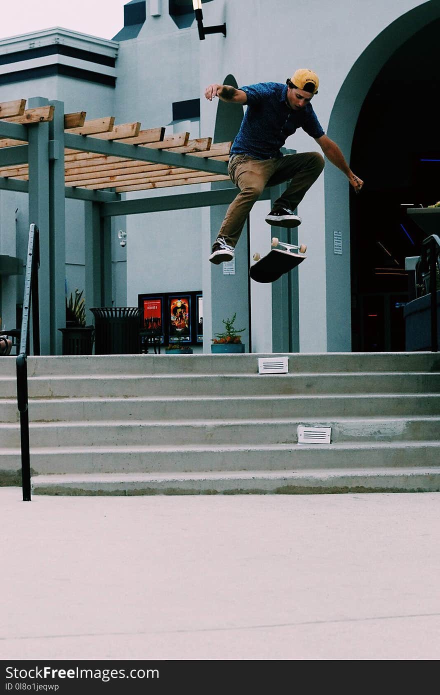 Man Jumping on Air over Flipped Skateboard