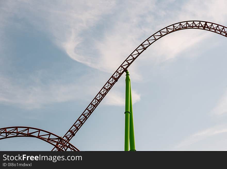 Gray Roller Coaster Taken Under White Clouds