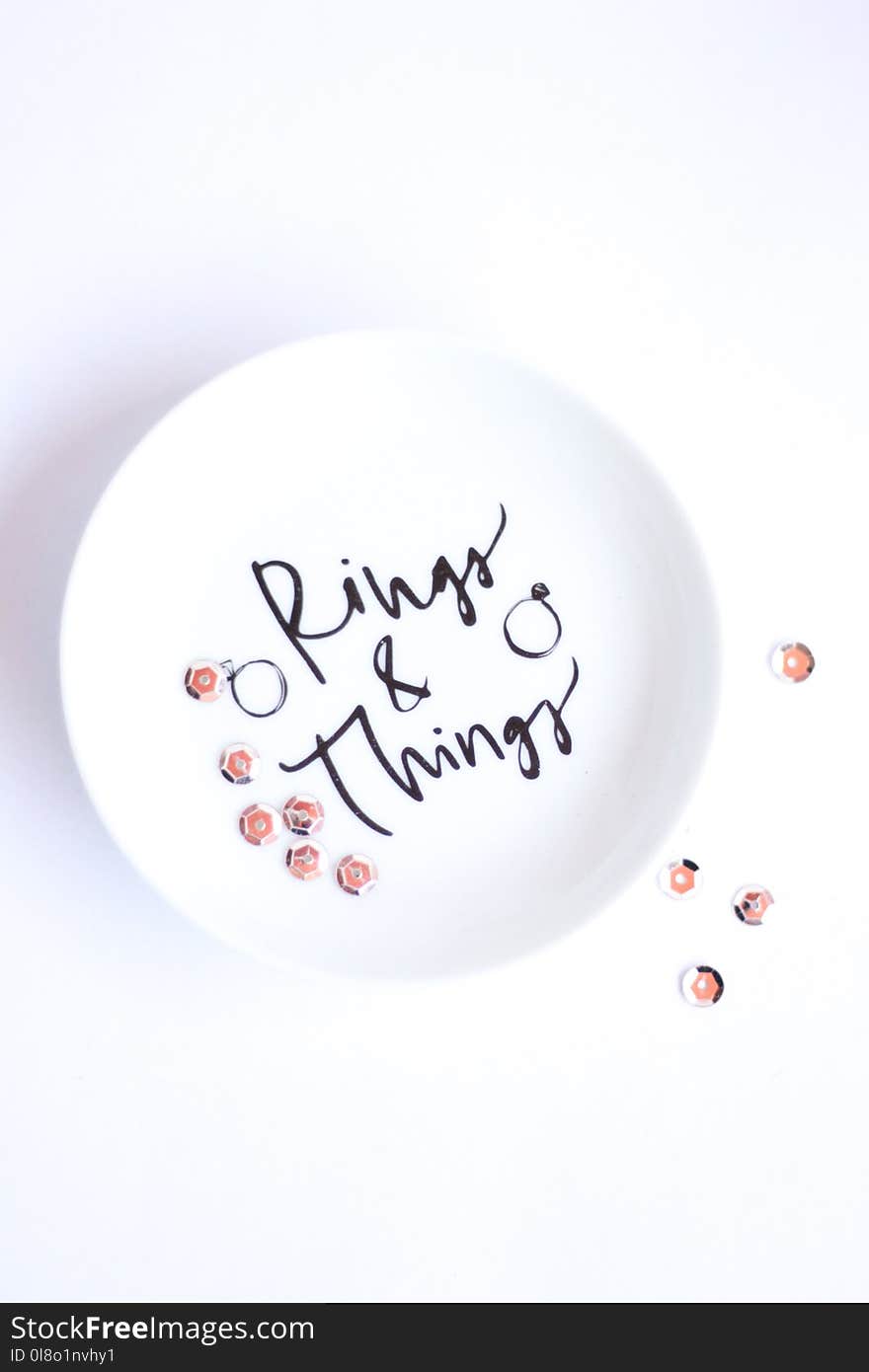 Silver-colored Rings on Round White Ceramic Plate