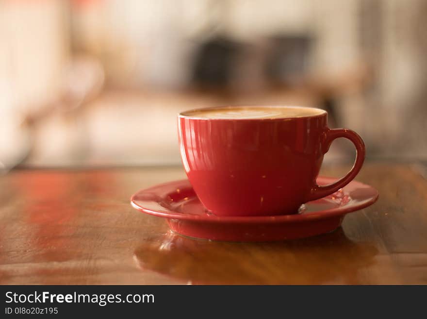 Red Ceramic Mug on Red Saucer