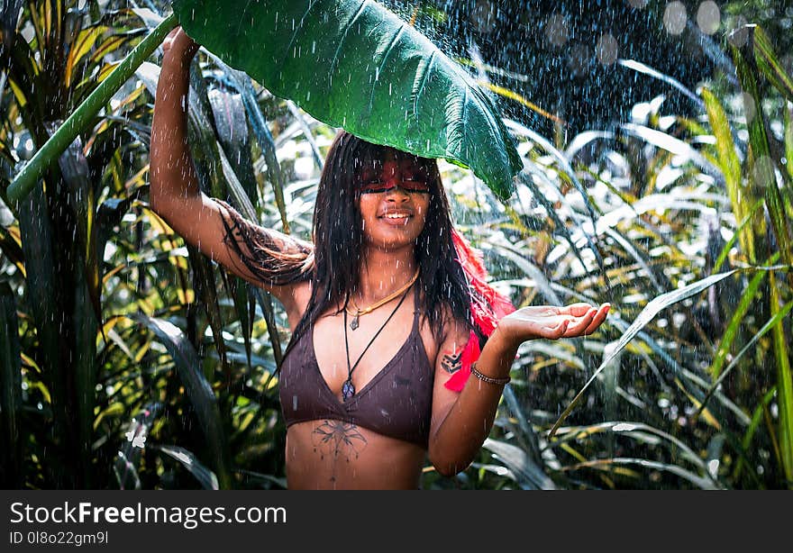 Woman in Black Bra Holding Big Leaf