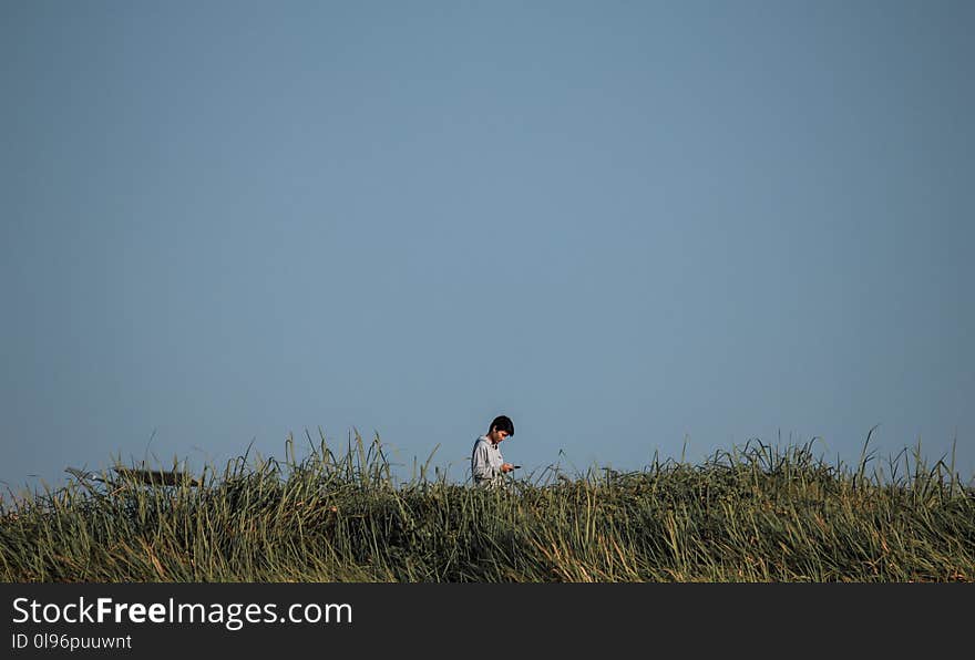 Man Standing On Green Grass