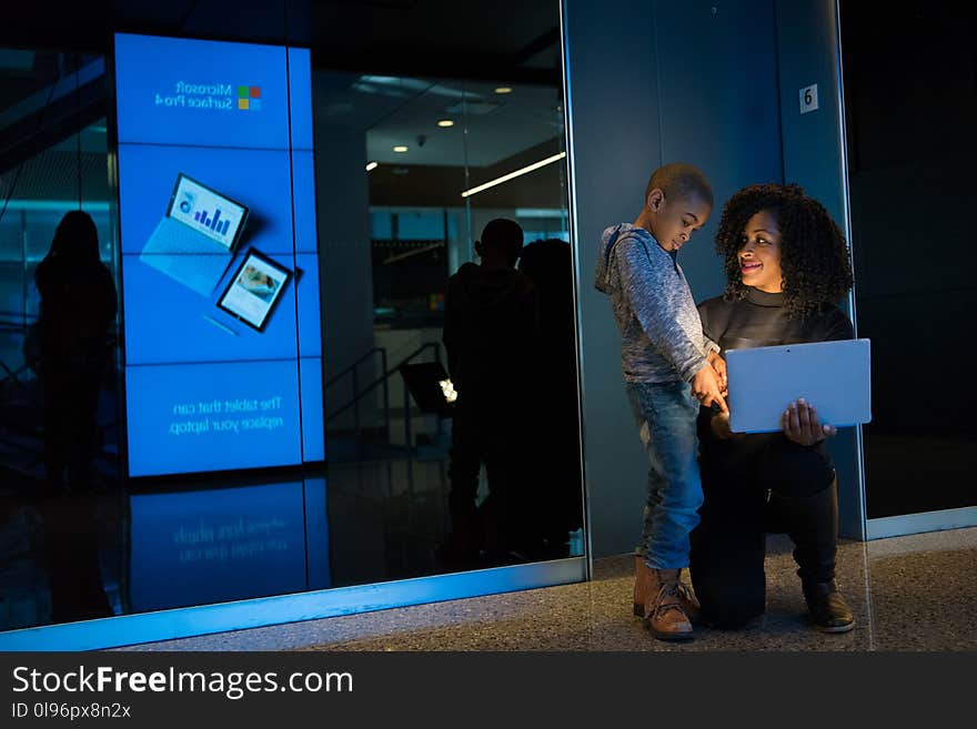 Woman Together With Children Holding Laptop Computer