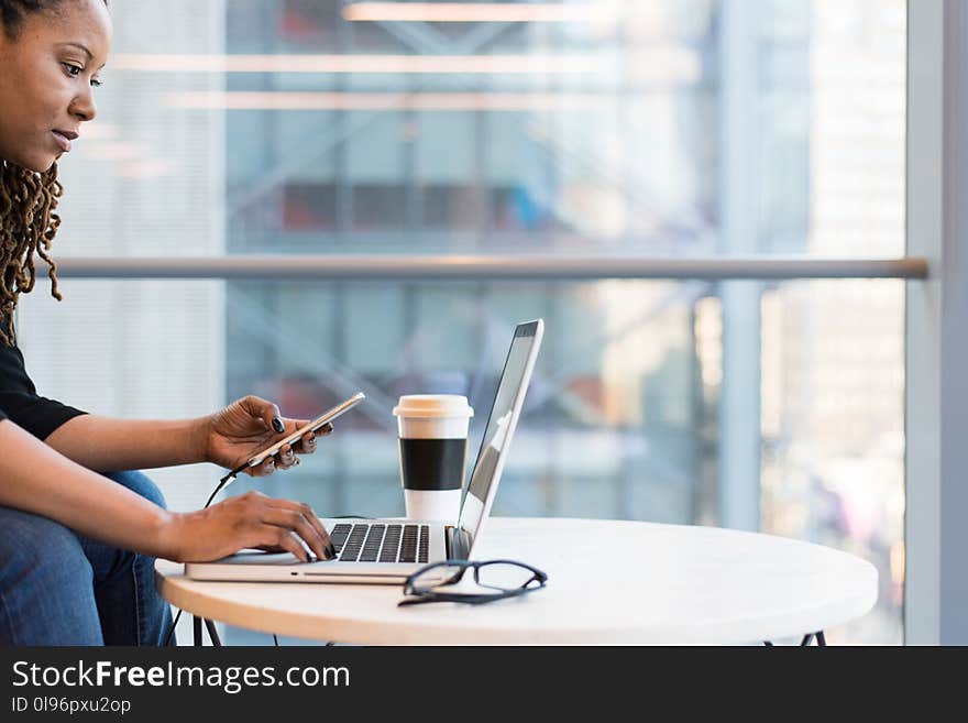 Woman Wearing Black Sweater Using Laptop Computer Inside the Room