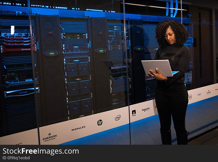 Woman Standing While Carrying Laptop