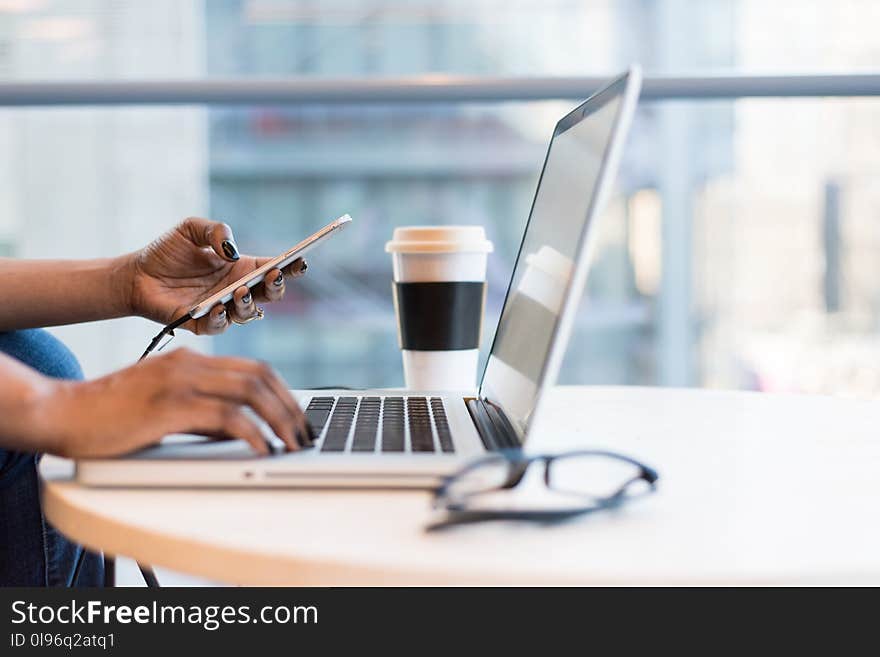 Person Using Macbook Air on Table