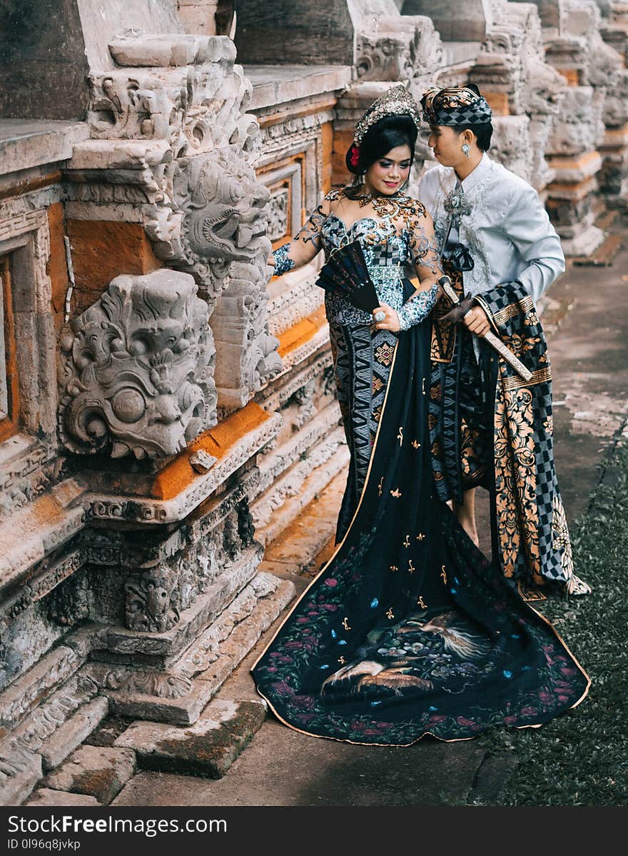 Photography of Woman in Black and Blue Lace Dress Beside Man