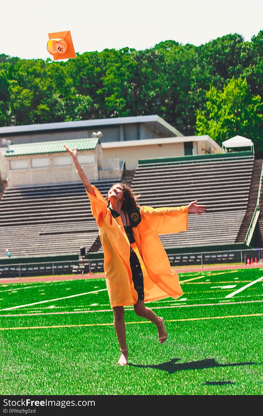 Woman in Orange Academic Dress