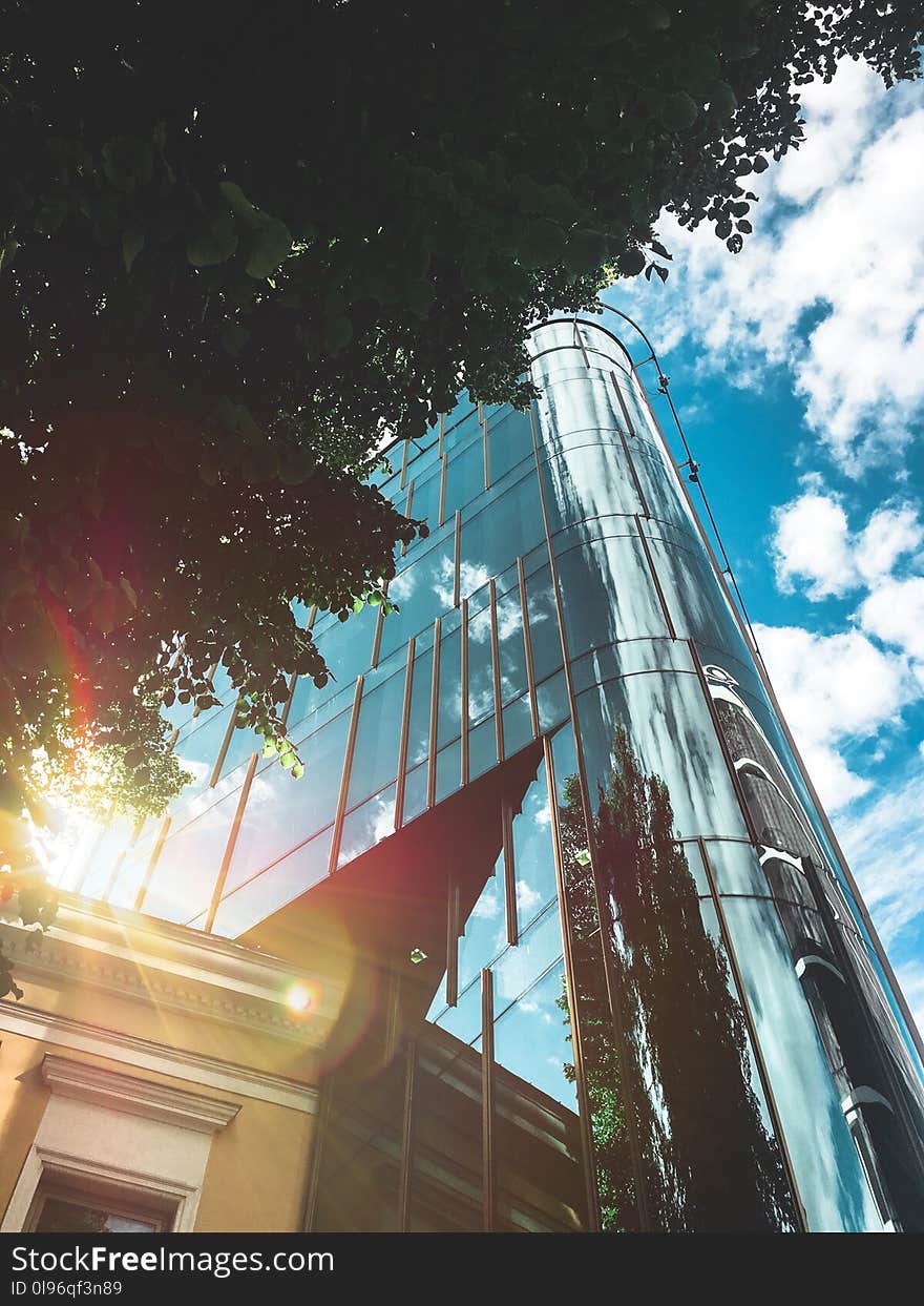 Low Angle Photo of High-rise Building over Blue and Cloudy Sky at Daytime