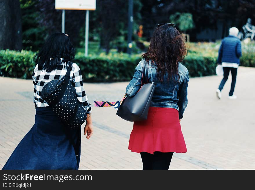 Woman in Blue Denim Jacket and Red Skirt