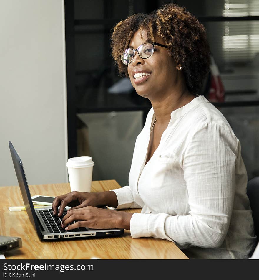 Woman in White Long-sleeved Top Using Laptop Computer