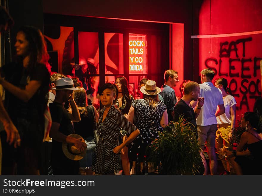 Group of People Standing Waiting Outside The Bar