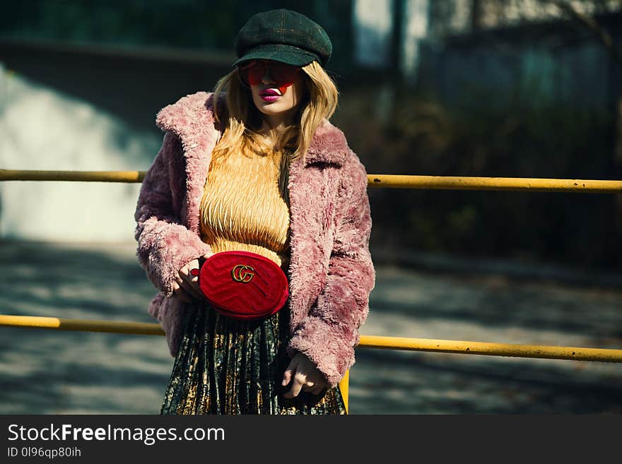 Woman Wearing Purple Coat Standing Near Body of Water