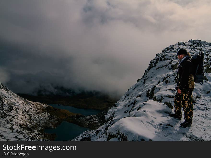 Hiker on Rocky Mountain overlooking Valley