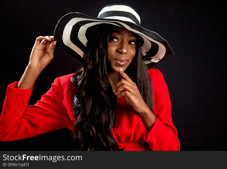 Woman Holding White and Black Hat