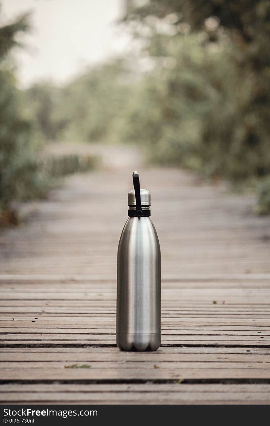 Vacuum Flask On Brown Wooden Dock