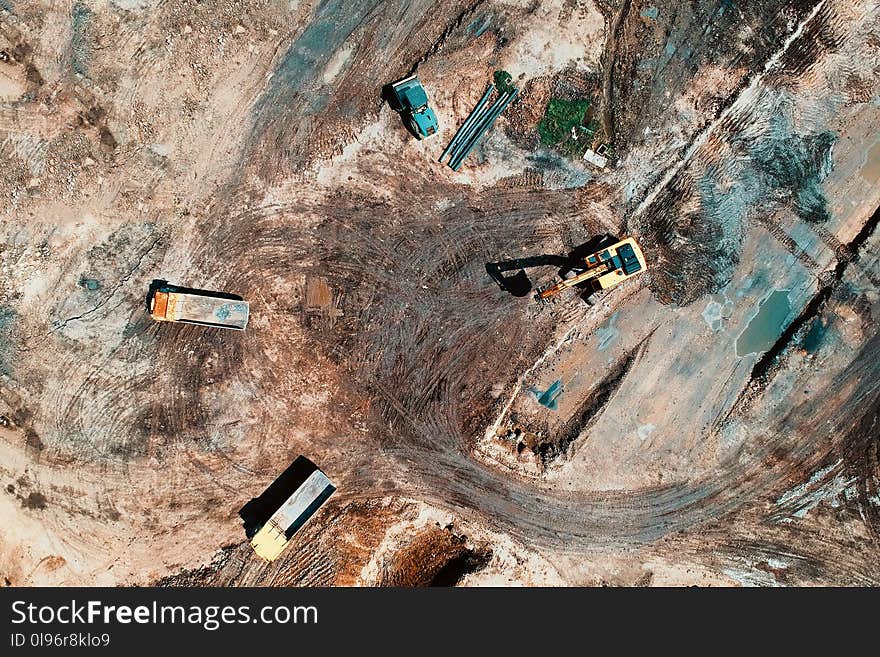 Aerial View Photography Of Utility Vehicles On Brown Soil