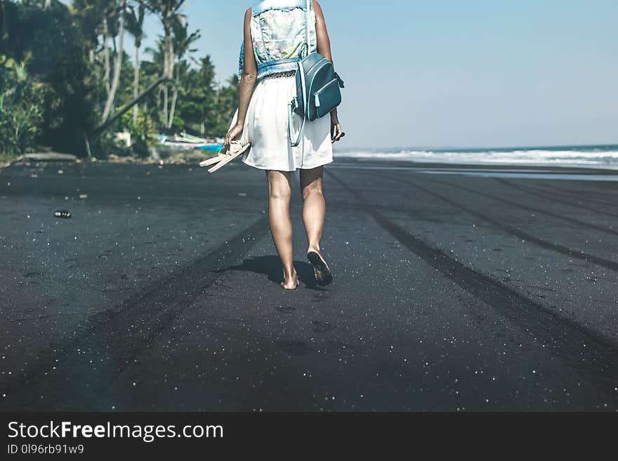 Woman Walking By The Sea