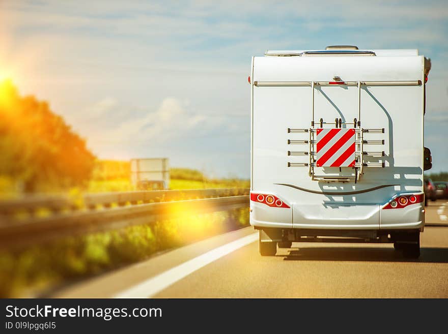 Camper Van Road Trip Vacation. Modern RV Class C Recreational Vehicle on the Highway.