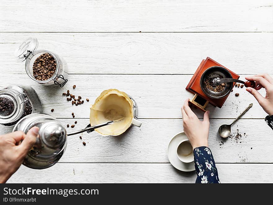 Person Holding Gray Teapot Pouring White Cup